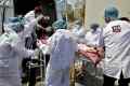 A patient is wheeled inside a COVID-19 hospital for treatment, in Ahmedabad
