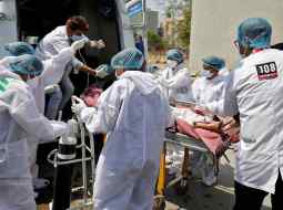 A patient is wheeled inside a COVID-19 hospital for treatment, in Ahmedabad