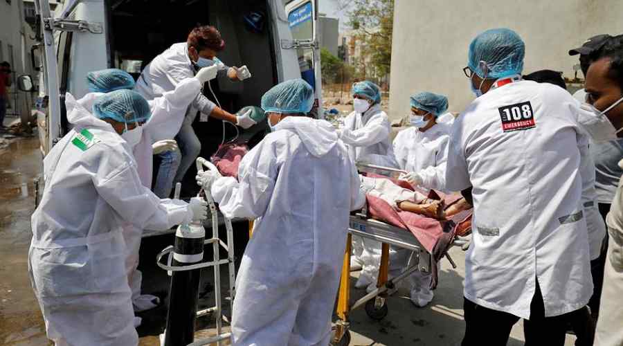 A patient is wheeled inside a COVID-19 hospital for treatment, in Ahmedabad